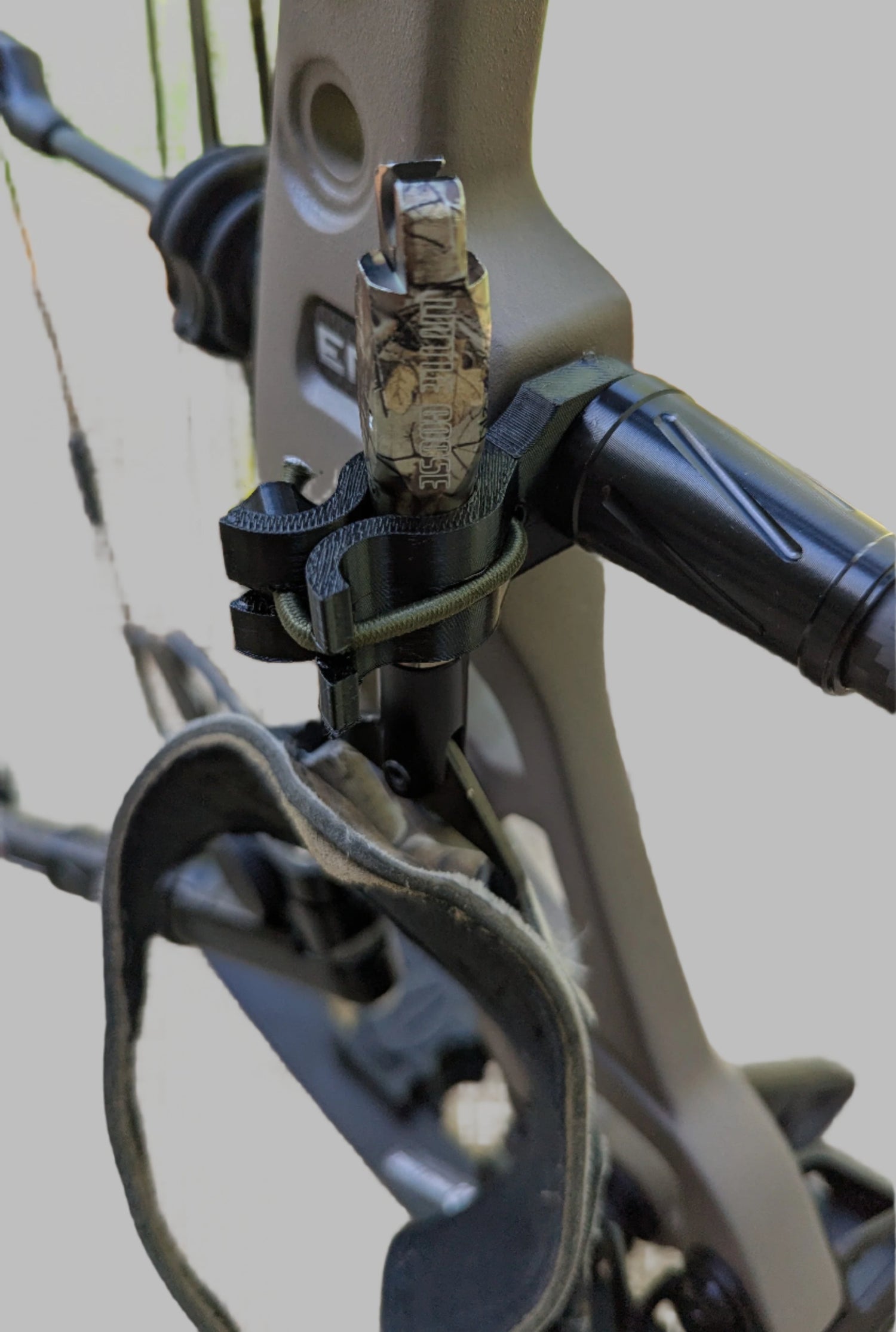 3D Hunting Solutions archery wrist release stabilizer holster for mobile and saddle hunting, attached to a bow for secure gear holding