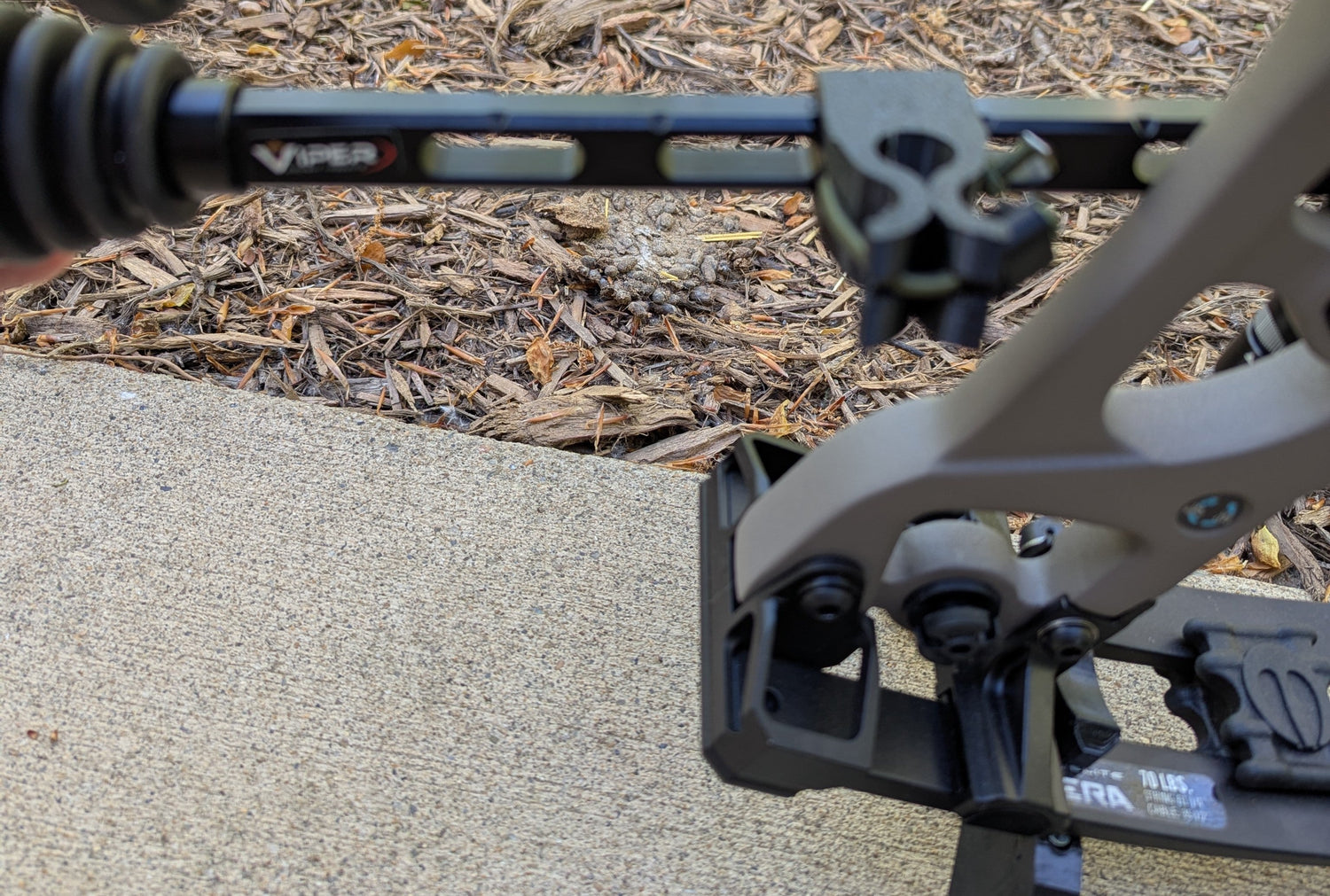 3D Hunting Solutions archery wrist release stabilizer holster for mobile and saddle hunting, attached to bow accessory in outdoor setting