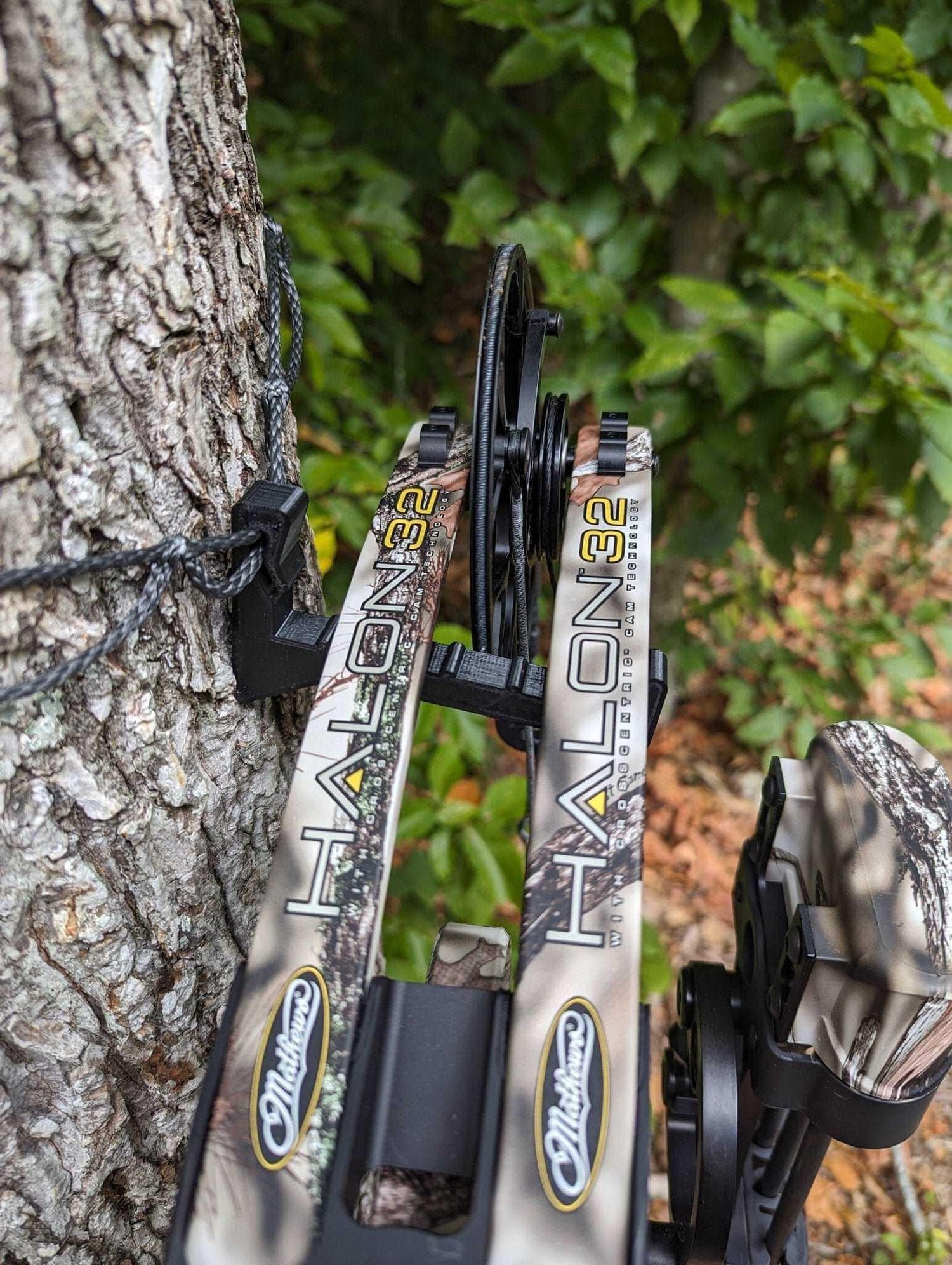 Amsteel bow hanger by 3D Hunting Solutions holding a bow, designed for secure bow storage and display.