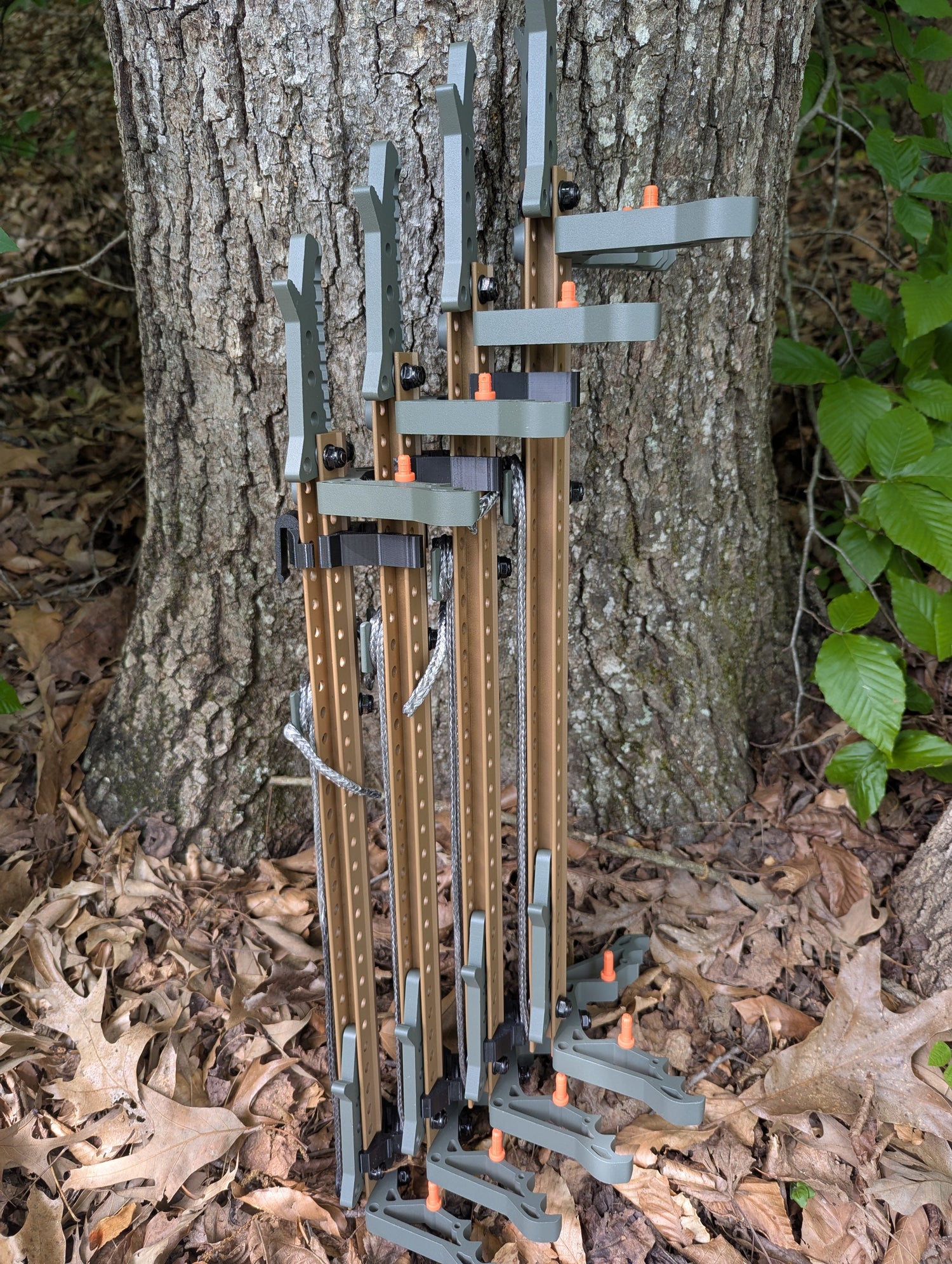 Set of Tethrd Skeletors Stick Wranglers by 3D Hunting Solutions for climbing stick management, with two stacked climbing sticks.