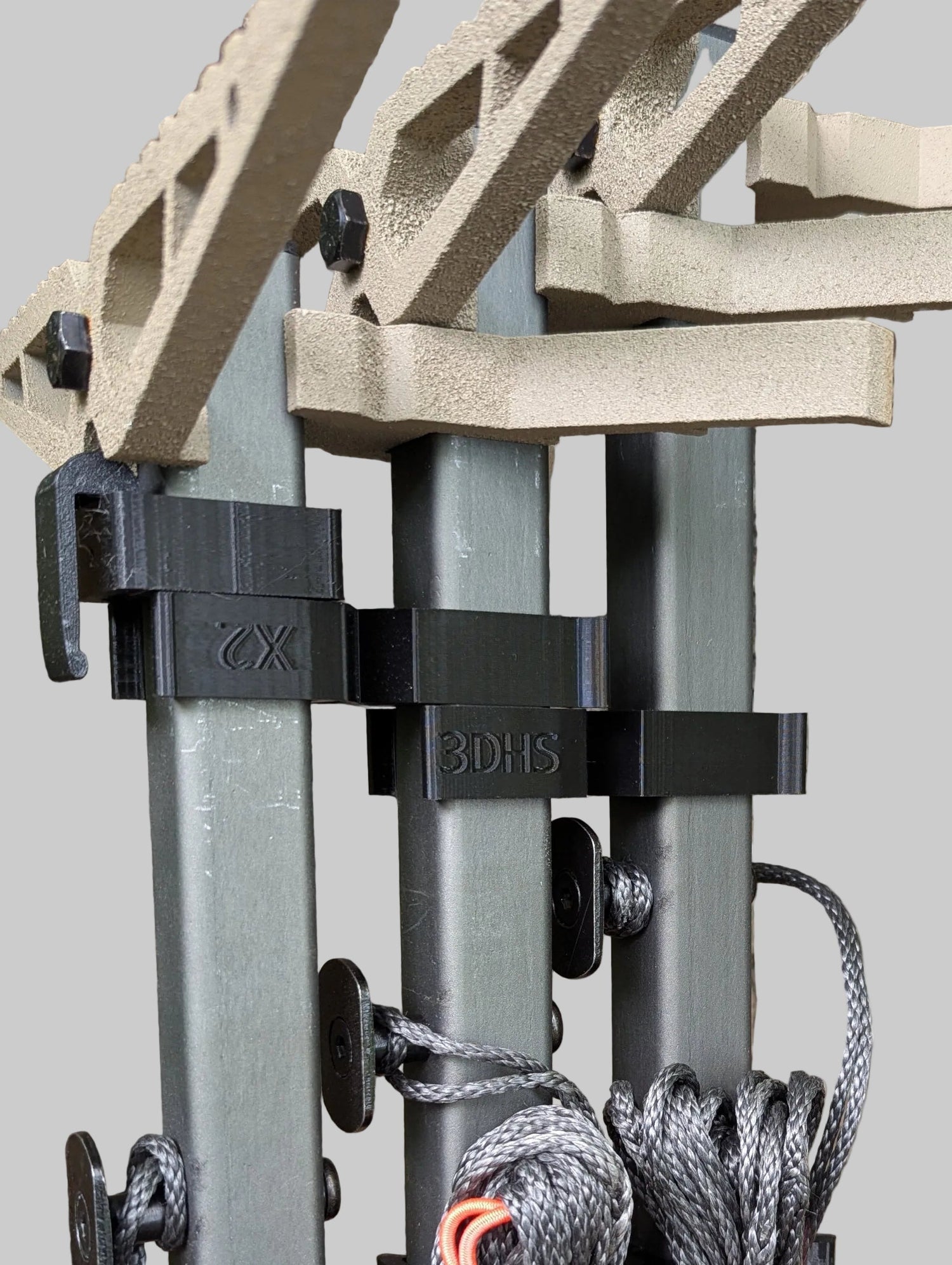 XOP X2 Stick Wranglers climbing stick management system by 3D Hunting Solutions, showing secure strap attachments on climbing sticks.