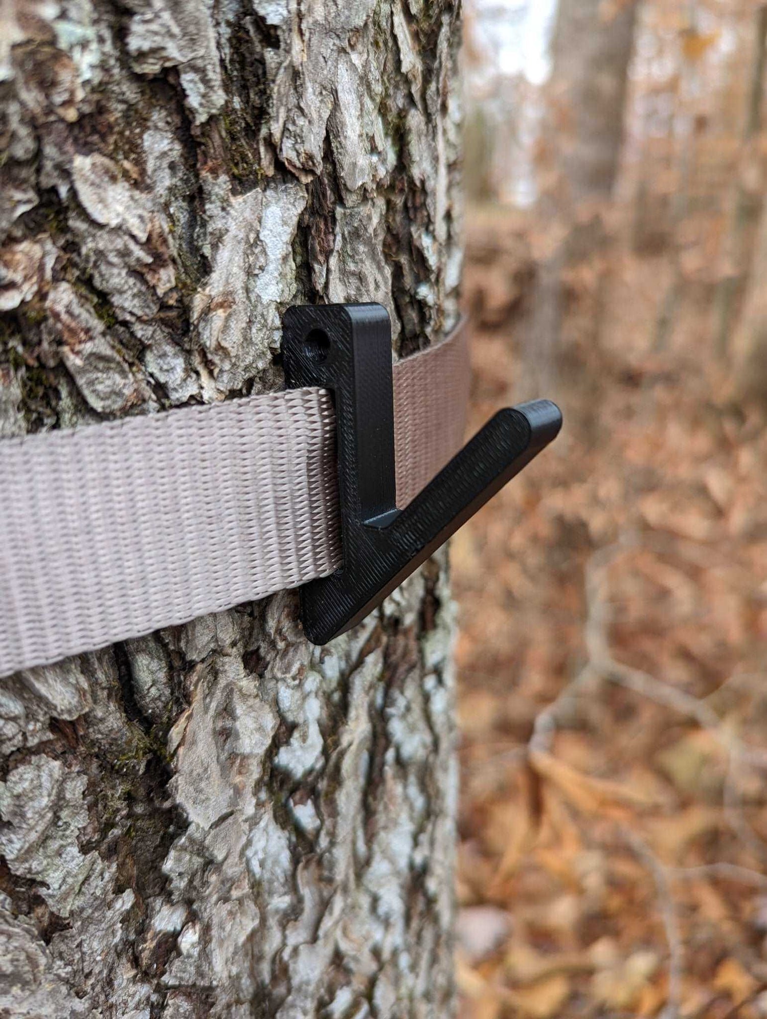 Angled gear hook attached to Amsteel strap for saddle hunting by 3D Hunting Solutions, holding hunting gear securely.