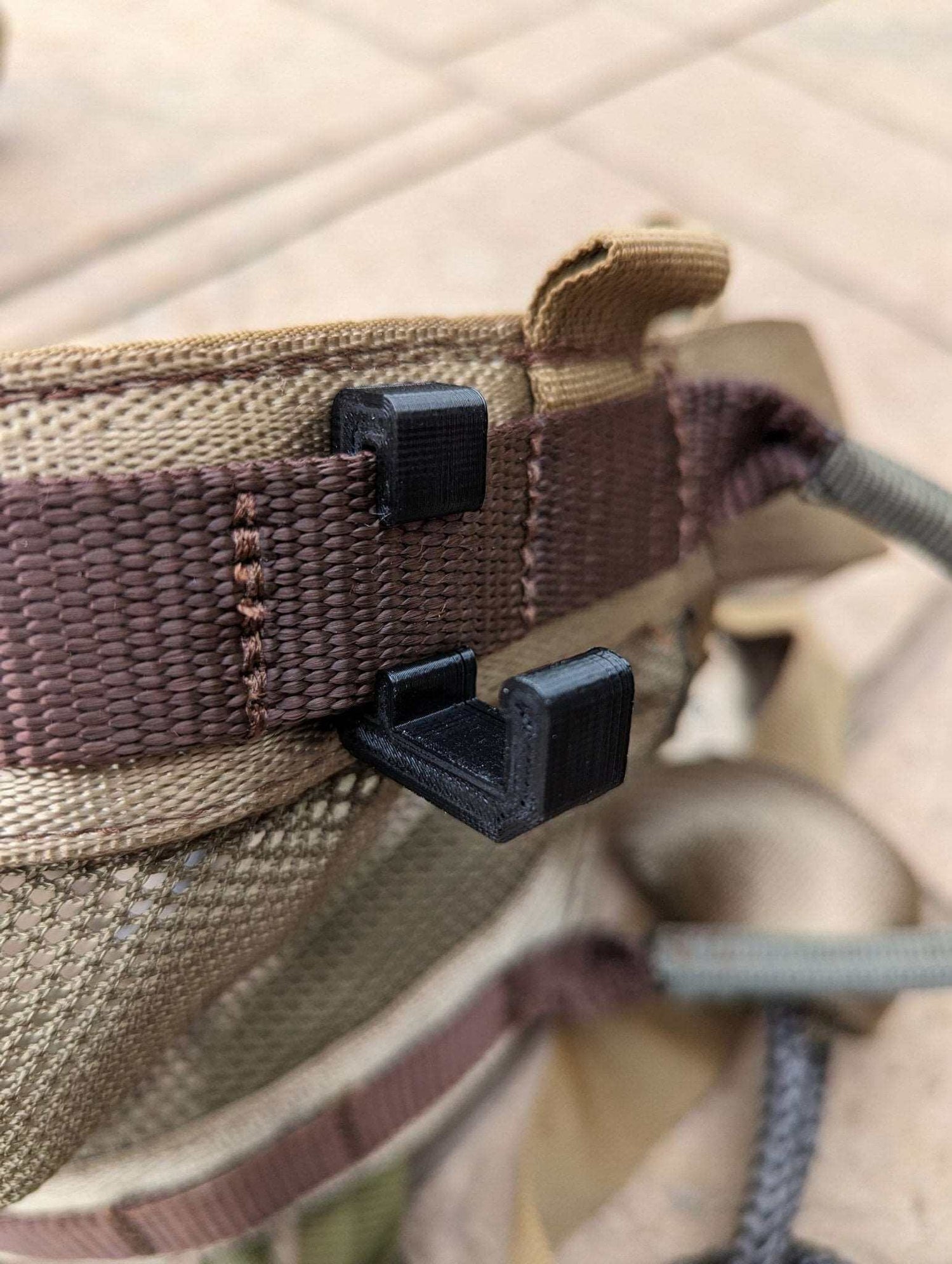 Climbing stick hanger by 3D Hunting Solutions, designed to securely hold climbing sticks for hunting or outdoor gear storage.