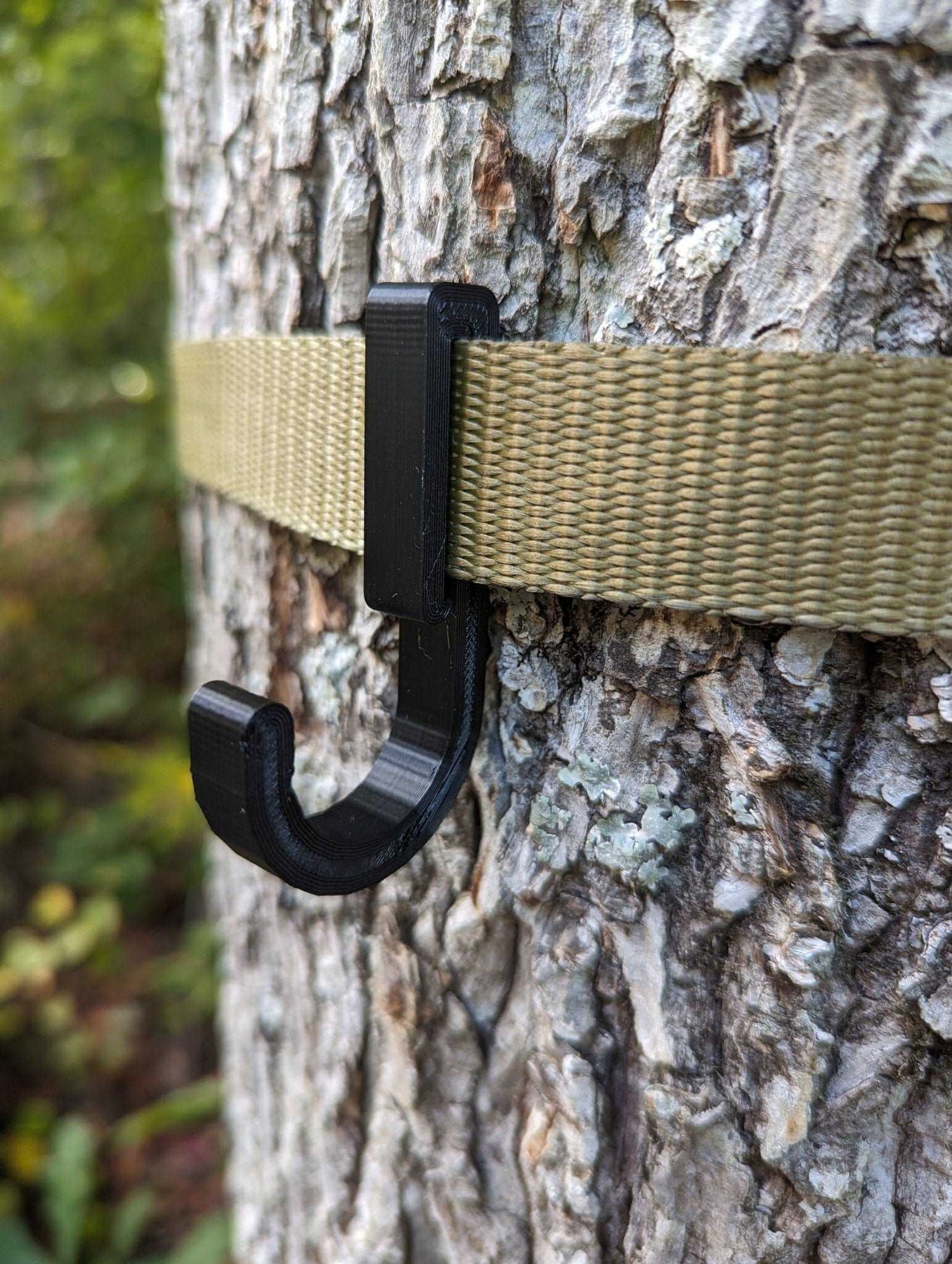 3D Hunting Solutions gear strap hook securely holds gear, featuring durable construction and a versatile design for outdoor use.