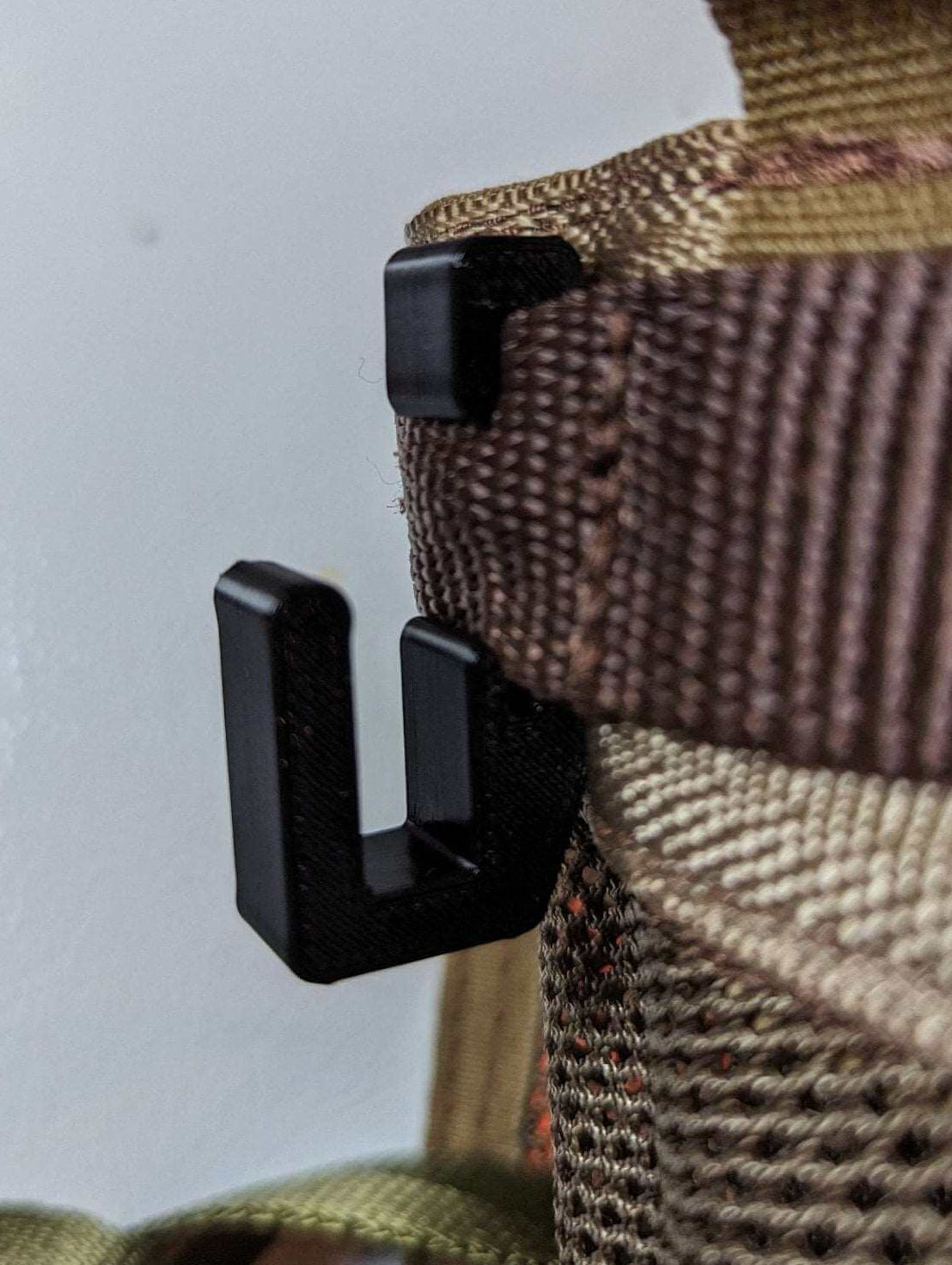 3D Hunting Solutions Tethrd One Skeletors climbing stick hanger attached to a tree for secure gear storage