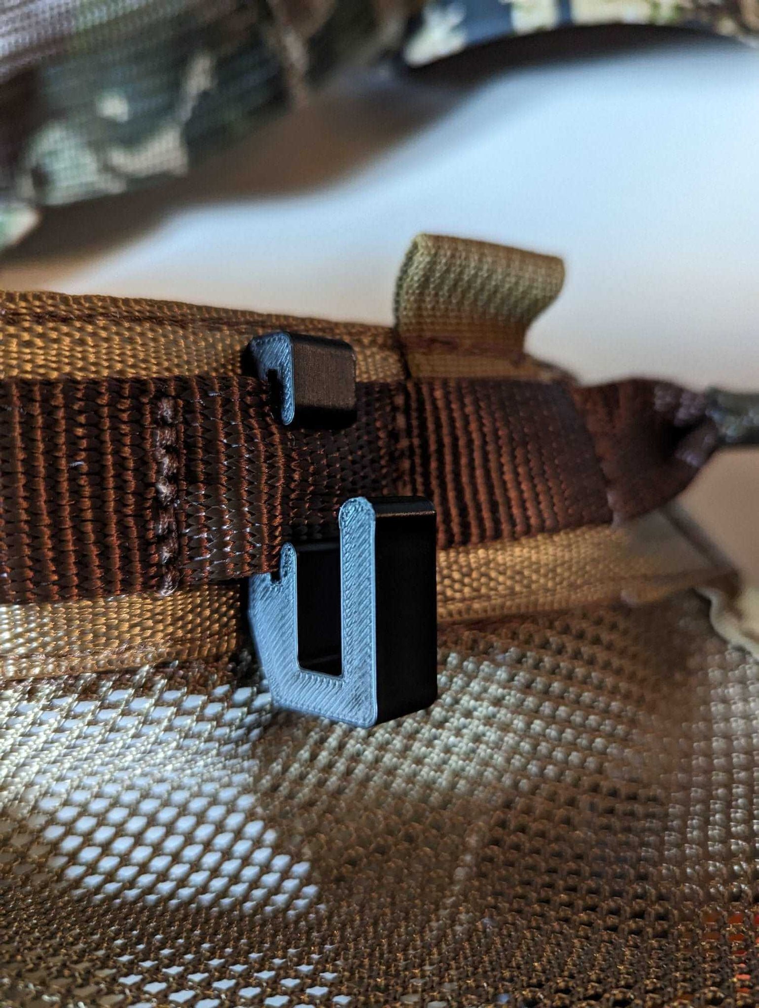 3D Hunting Solutions Tethrd One Skeletors climbing stick hanger attached to a tree for secure gear storage.