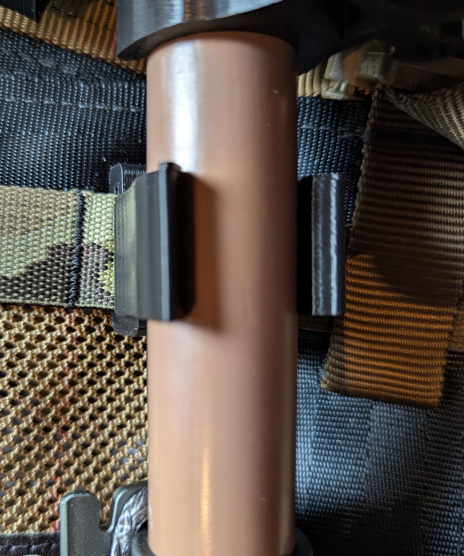 3D Hunting Solutions Tethrd One Molle Caddy attached to saddle hunting gear, showing storage compartments and mounting straps.