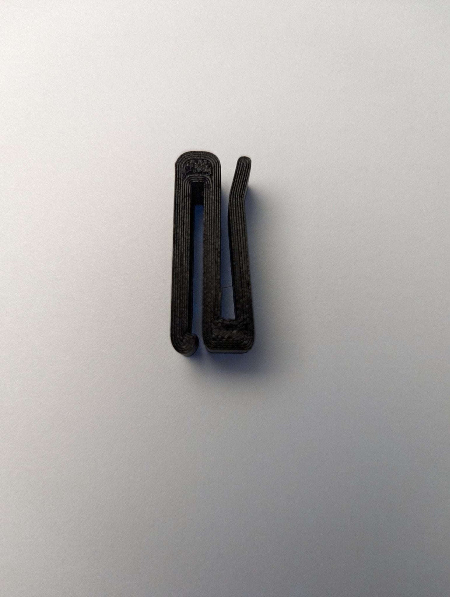 3D Hunting Solutions Molle Hook Hanger for outdoor gear and tactical equipment, durable metal design.
