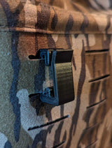 3D Hunting Solutions Molle hook hanger for tactical gear, shown attached to a molle webbing system in a close-up view.