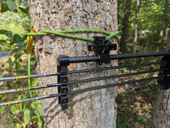 Molle Tight Spot Archery Quiver Caddy by 3D Hunting Solutions mounted on a bow for easy arrow and accessory storage.