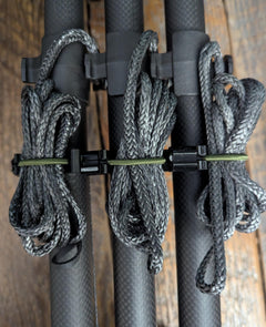 Climbing stick attachment bundler by 3D Hunting Solutions, securely holding climbing sticks for easy transport and setup