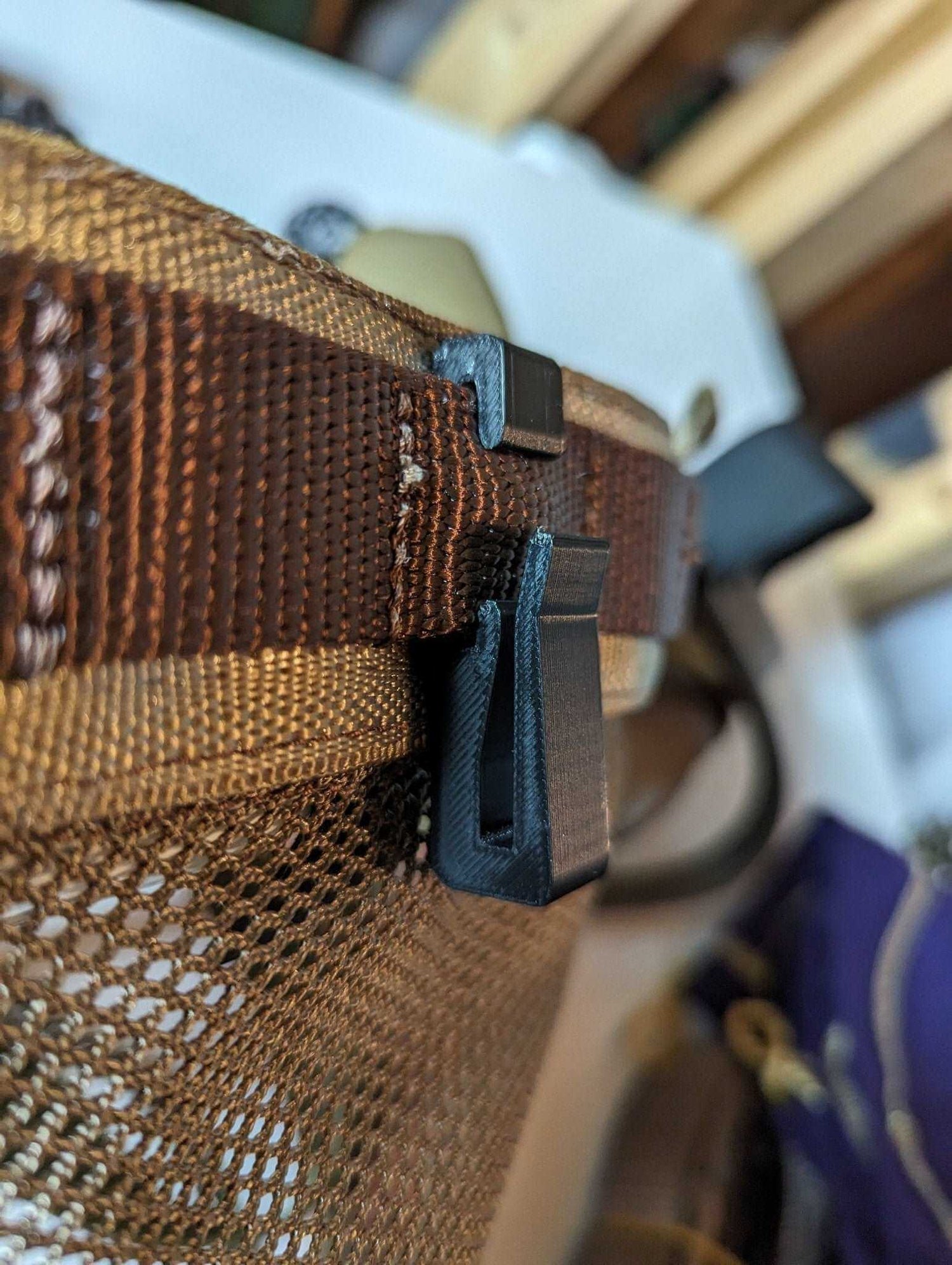XL Molle hook and hanger for saddle hunting by 3D Hunting Solutions, featuring durable steel construction and versatile attachment points.