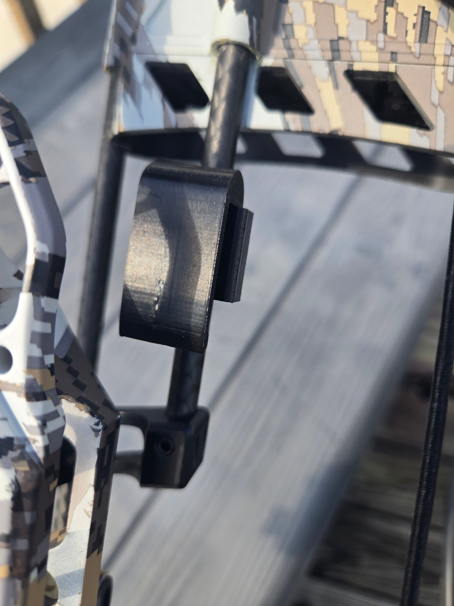 Clip-on archery quiver hanger by 3D Hunting Solutions, showing secure clip and sturdy design for archery gear attachment.
