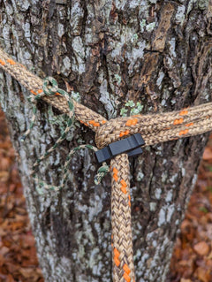 8mm tether rope clip for saddle hunting by 3D Hunting Solutions, shown attached to a saddle for secure gear attachment.