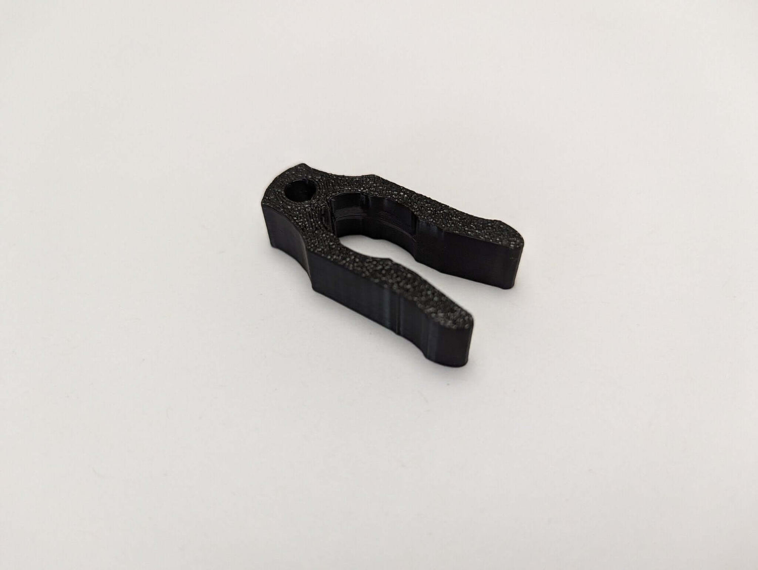 8mm tether rope clip for saddle hunting by 3D Hunting Solutions, shown attached to hunting gear.