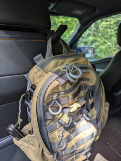 3D Hunting Solutions arrow accessory headrest post with bow and gear hanger mounted on vehicle headrest.