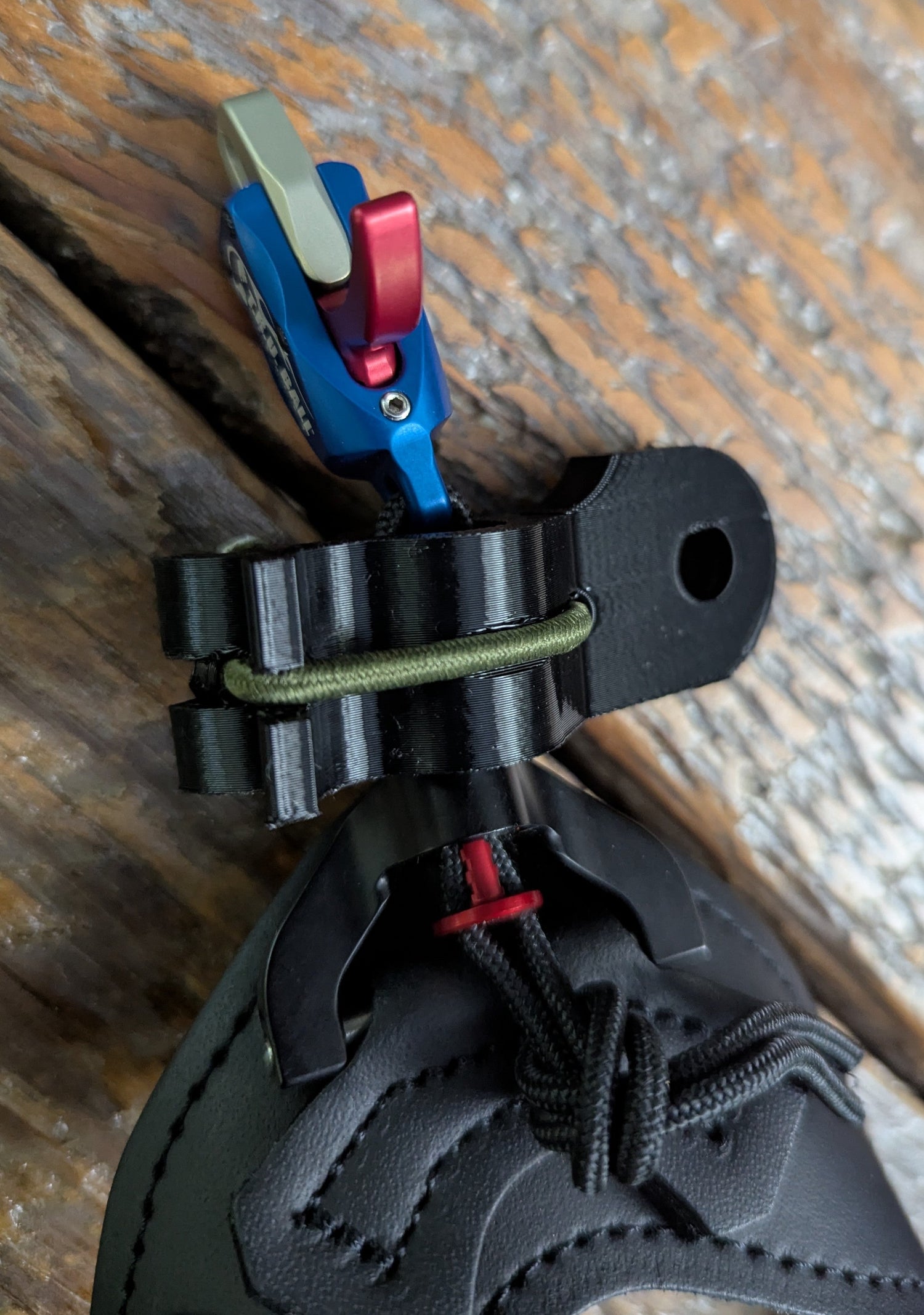 3D Hunting Solutions archery wrist release stabilizer holster for mobile and saddle hunting, attached to a bow for secure gear access.