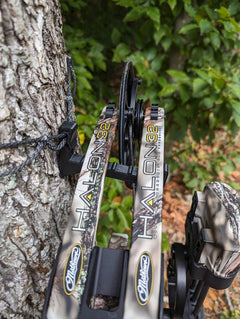 Amsteel Bow Hanger by 3D Hunting Solutions displaying a sturdy steel hook for hanging bows in a natural outdoor setting.
