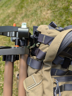 3D Hunting Solutions Molle Reverser Clip attached to climbing sticks, showing secure Molle loop for gear attachment.