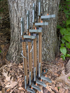 Set of Tethrd Skeletors Stick Wranglers by 3D Hunting Solutions for climbing stick management, with two stacked climbing sticks.