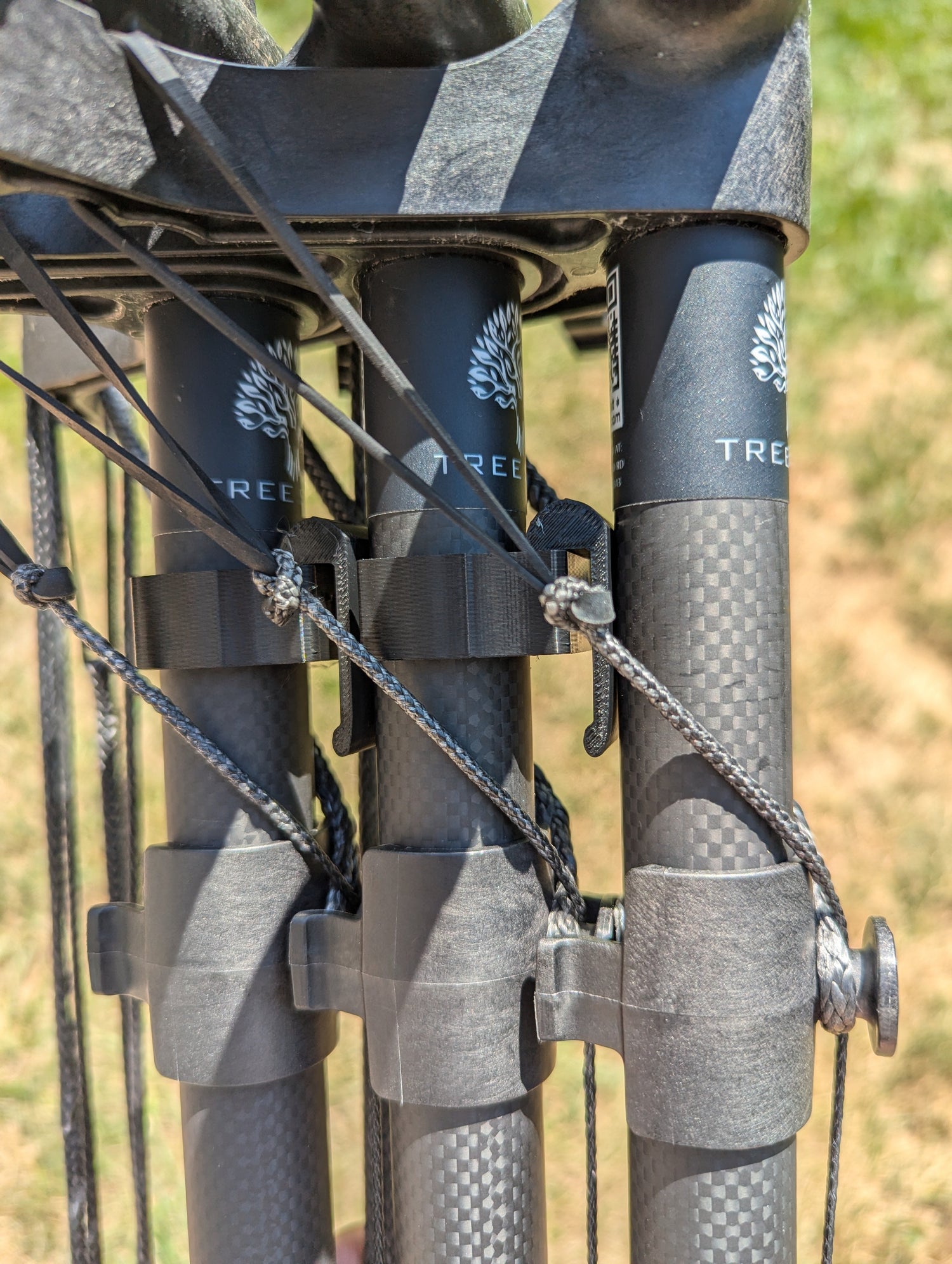 TreeStyx Synergy Stick Caddy for saddle hunting, 3D Hunting Solutions climbing stick accessory, holding gear securely.