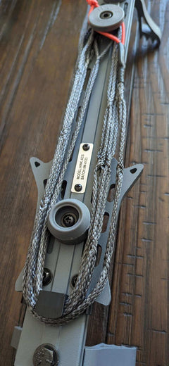 Hawk Helium Amsteel Spooler attached to 3D Hunting Solutions climbing sticks for secure rope handling during climbing.