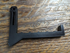 Bow hanger made of Amsteel strap by 3D Hunting Solutions, shown hanging securely in a natural outdoor setting