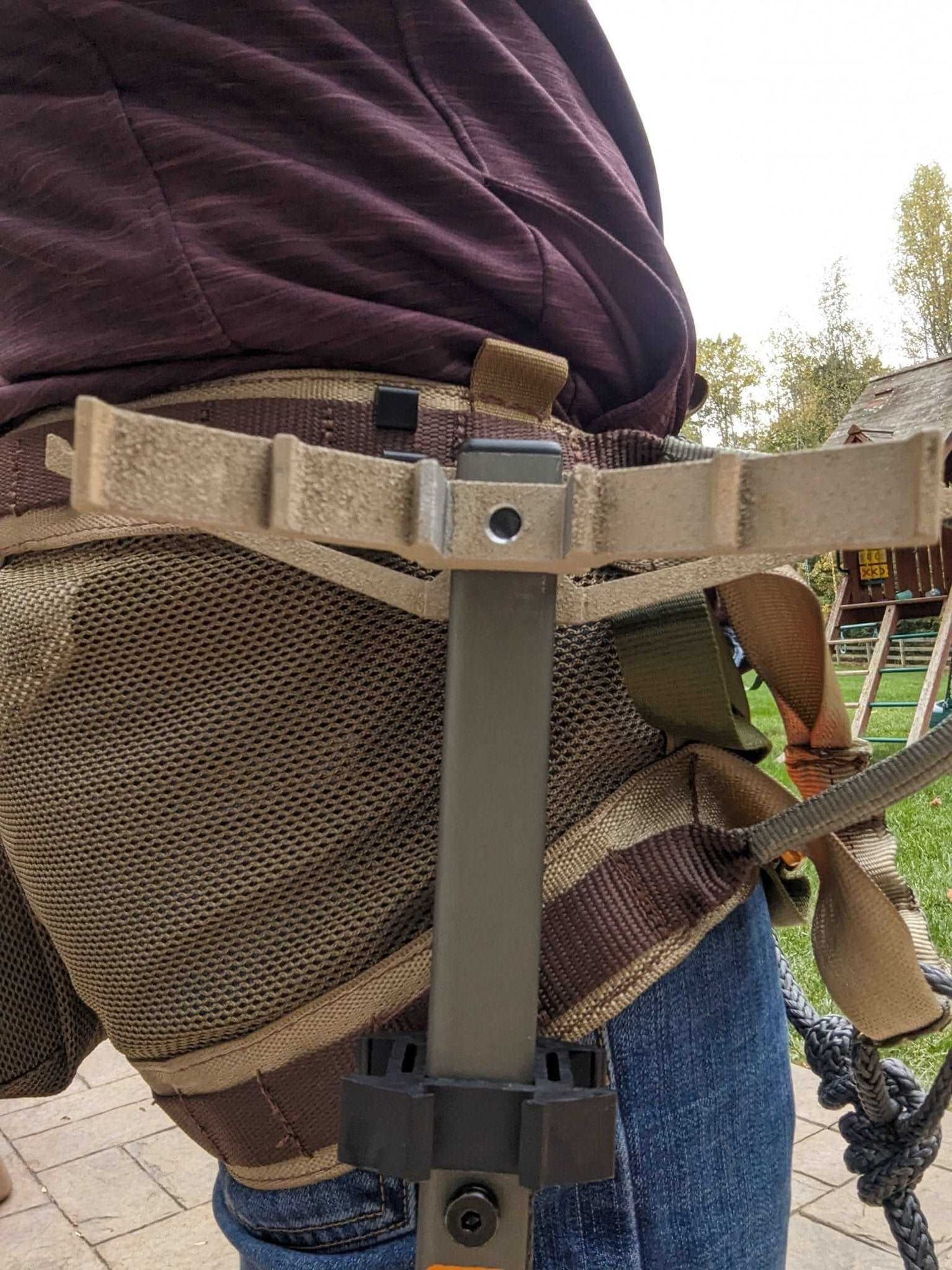3D Hunting Solutions climbing stick hanger for secure outdoor gear storage, shown hanging on a tree branch.