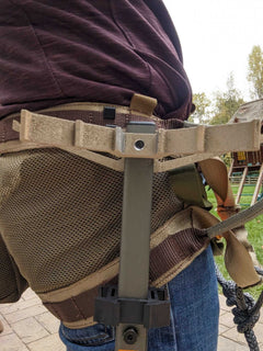 3D Hunting Solutions climbing stick hanger for secure outdoor gear storage, shown hanging on a tree branch.