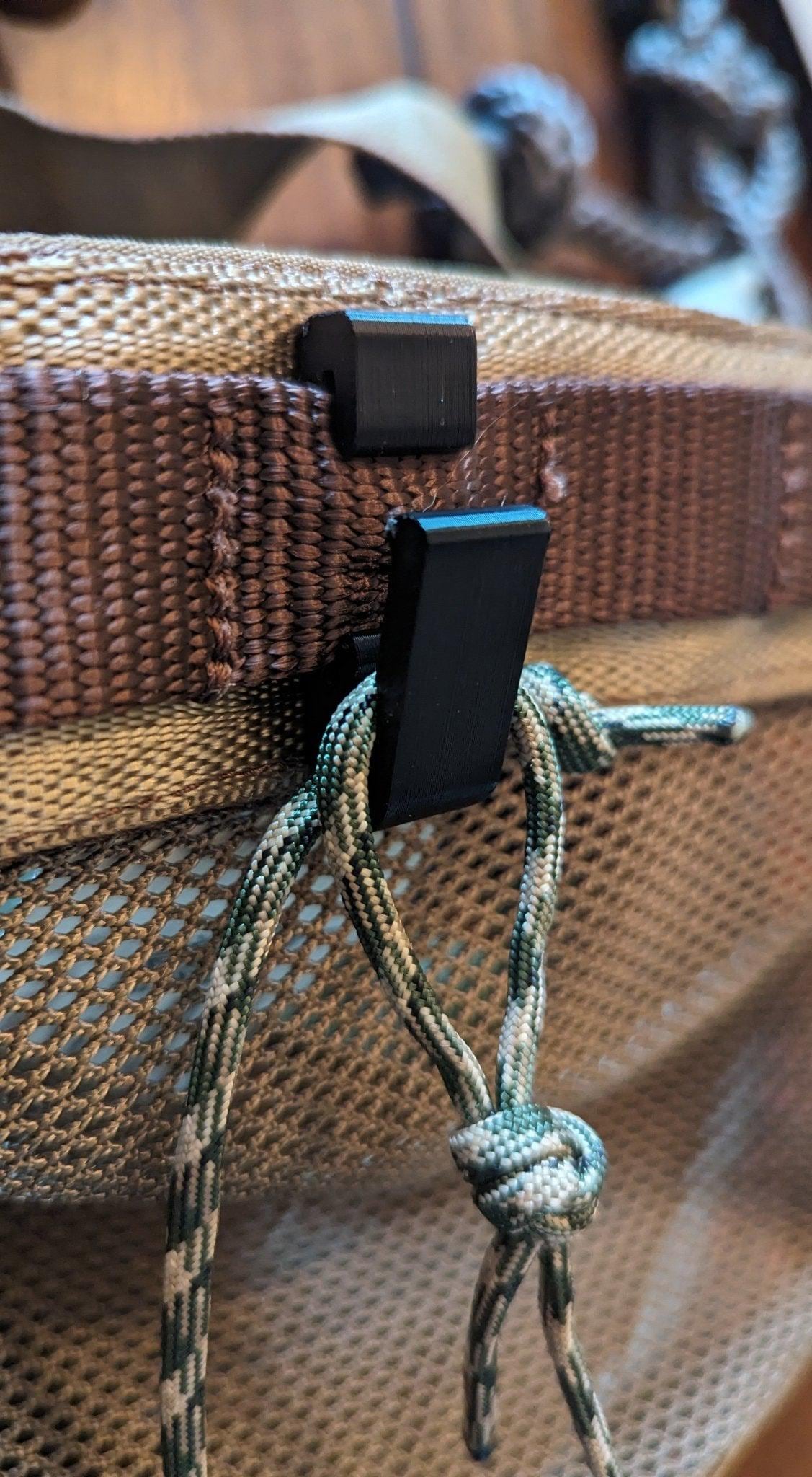 3D Hunting Solutions Rope Molle hanger hook for saddle hunting, shown attached to a tree with gear ready for use.