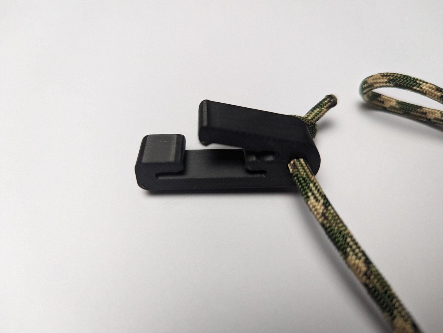Rope Molle hanger hook for saddle hunting by 3D Hunting Solutions, shown attached to hunting gear for secure equipment storage.