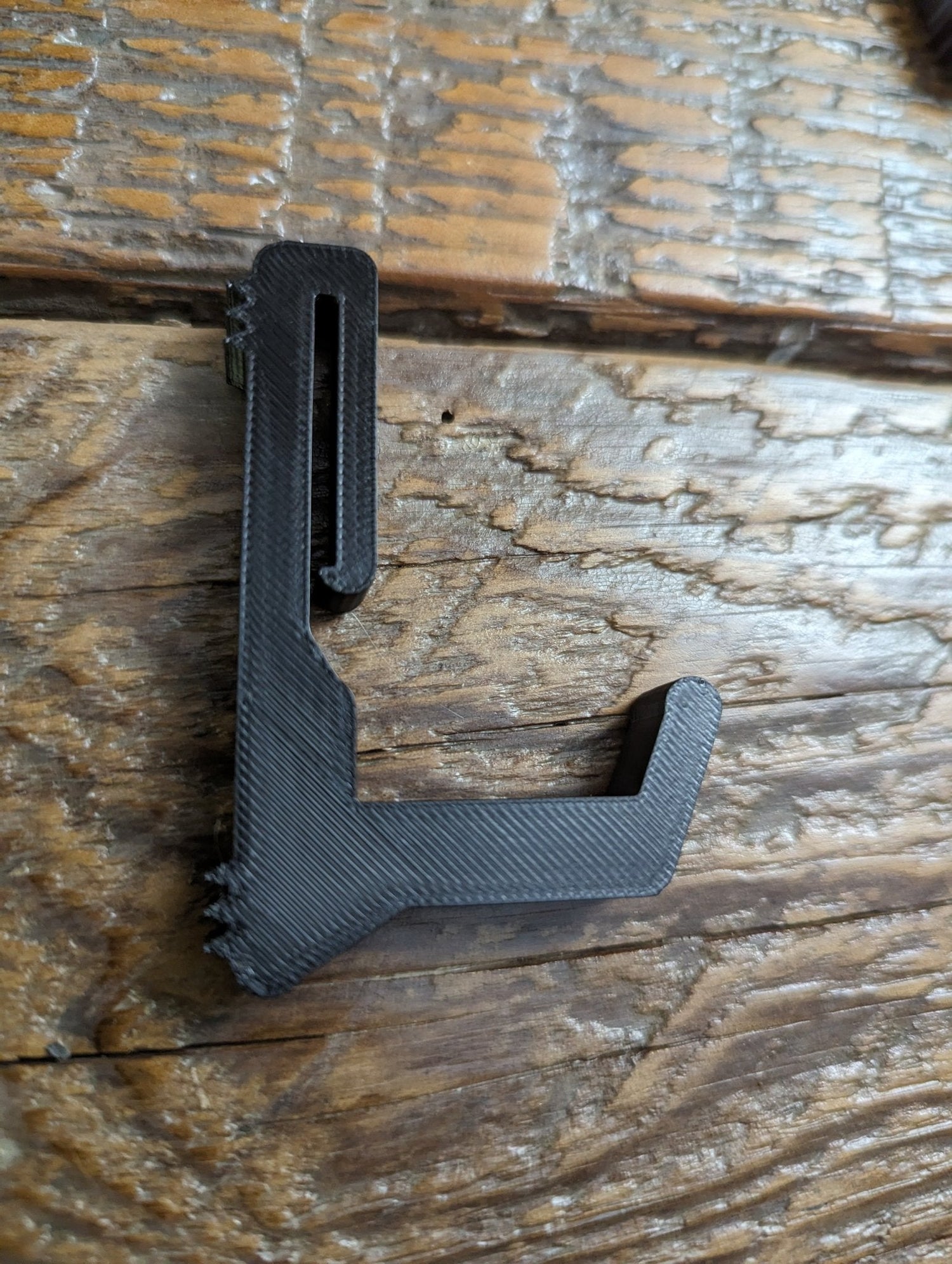 Split limb bow hanger gear strap for saddle hunting by 3D Hunting Solutions, shown attached to a tree for easy bow storage