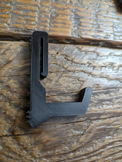 Split limb bow hanger gear strap for saddle hunting by 3D Hunting Solutions, shown attached to a tree for easy bow storage