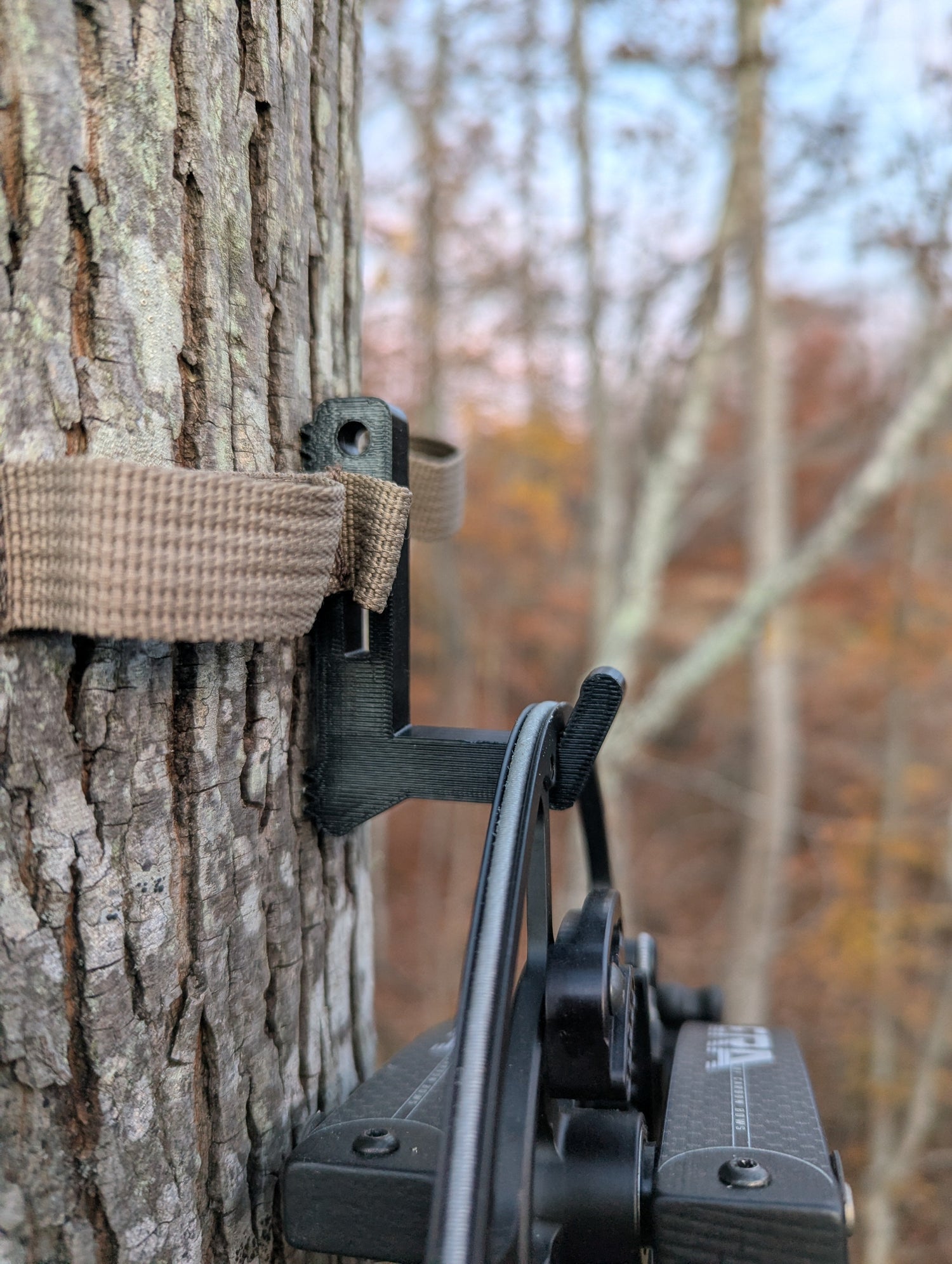 Split limb bow hanger from 3D Hunting Solutions with rope or strap for secure archery equipment storage.