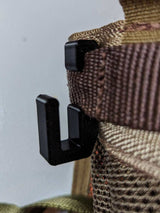 3D Hunting Solutions Tethrd One Skeletors climbing stick hanger mounted on a tree for secure gear hanging.
