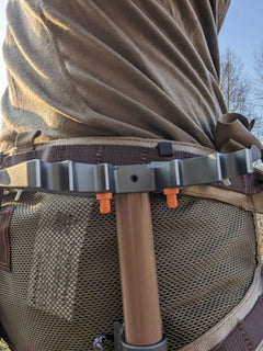 3D Hunting Solutions Tethrd One Skeletors climbing stick hanger mounted on a tree for secure gear hanging during hunting trips.