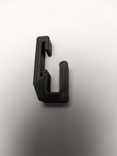 3D Hunting Solutions Tethrd One Skeletors Climbing Stick Hanger mounted on a tree for secure climbing gear storage.