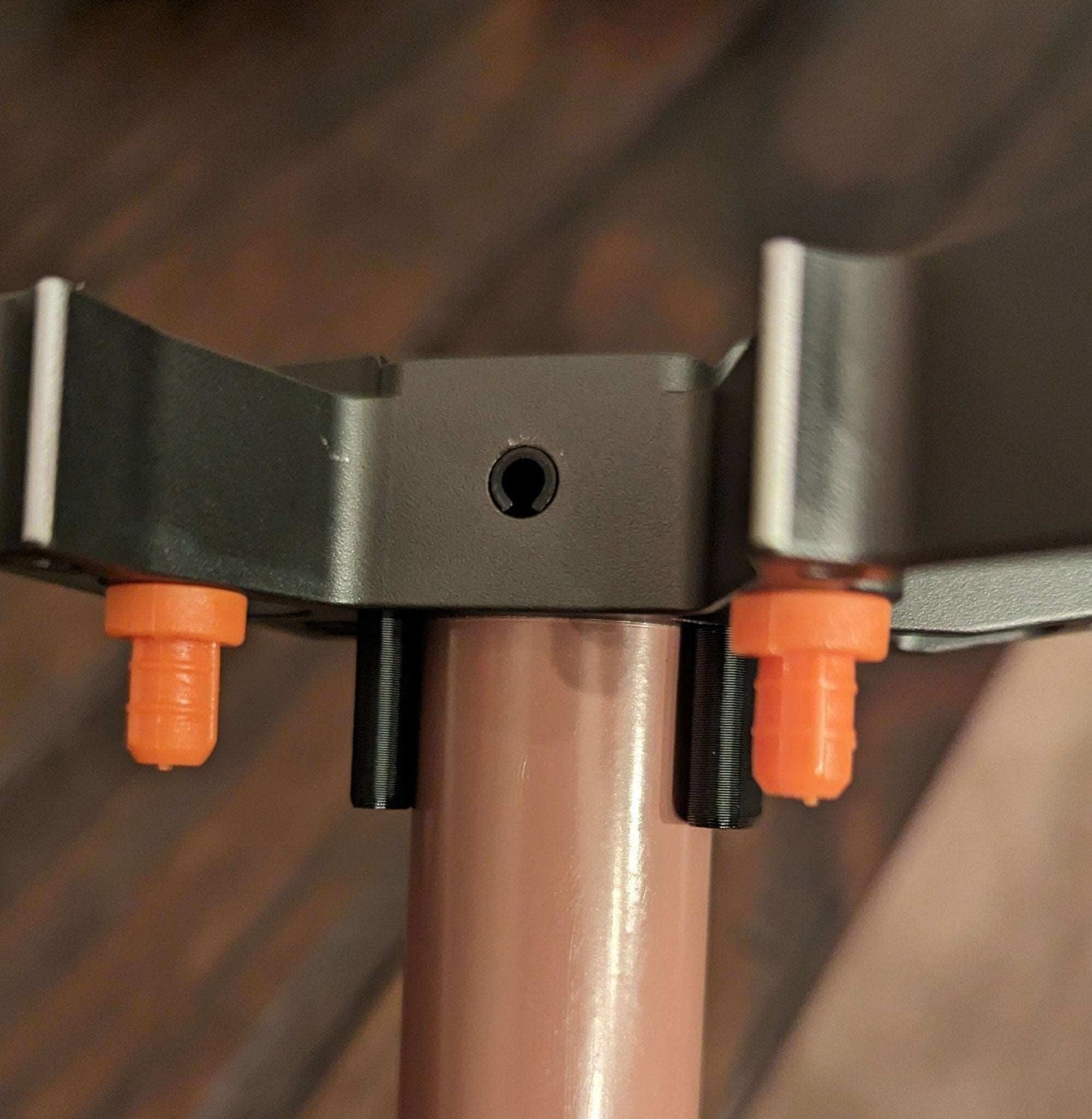 Tethrd One Stick Caddy for saddle hunting by 3D Hunting Solutions, shown attaching to a saddle for easy gear access.