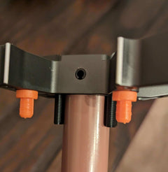 Tethrd One Stick Caddy for saddle hunting by 3D Hunting Solutions, shown attaching to a saddle for easy gear access.