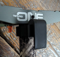 3D Hunting Solutions Tethrd One Stick Caddy mounted on saddle hunting gear for secure tool storage during hunting.