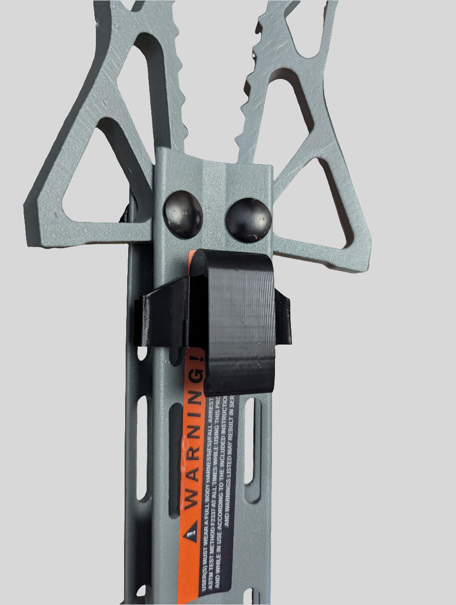 Hawk Helium Stick Caddy by 3D Hunting Solutions attached to saddle hunting gear for secure climbing and equipment organization
