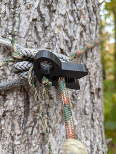 T-REX Tether Clip by 3D Hunting Solutions, versatile tether clip for mobile and saddle hunting, shown on a hunting setup.