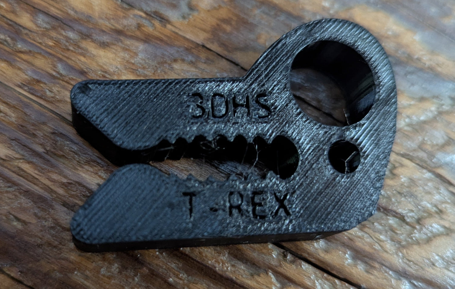 T-REX Tether Clip by 3D Hunting Solutions for mobile and saddle hunting, shown attached to hunting gear in outdoor setting.