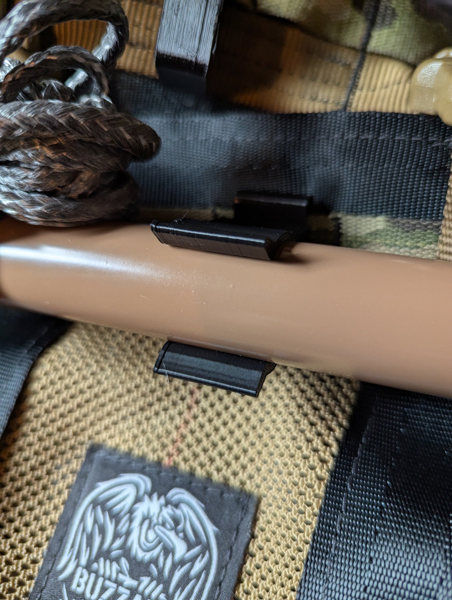 Vertical Tethrd One Molle Caddy for saddle hunting by 3D Hunting Solutions, mounted on a hunting saddle with molle webbing.