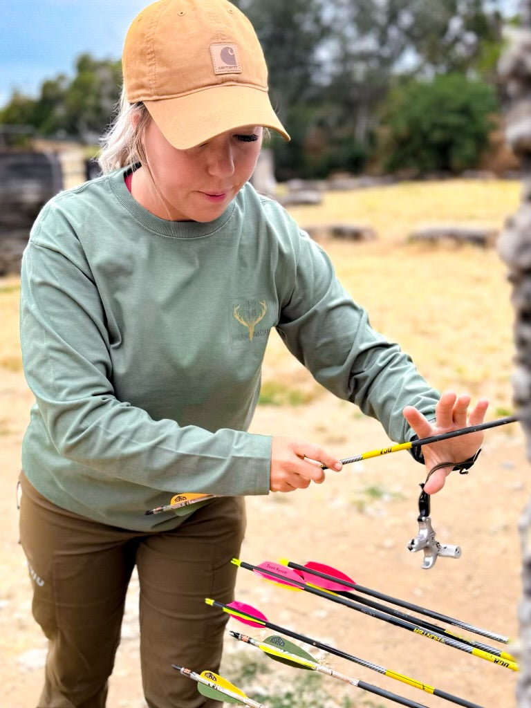 Green Hunting Life Long Sleeve shirt by Bow Disciples, shown with a close-up of the fabric and branding details.