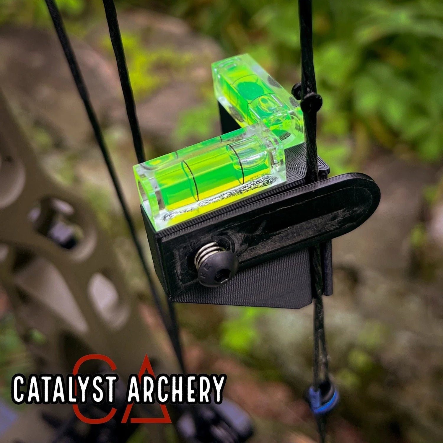 Catalyst Archery bow string level tool showing a small, clear bubble level mounted on a black plastic frame for archery bow tuning.