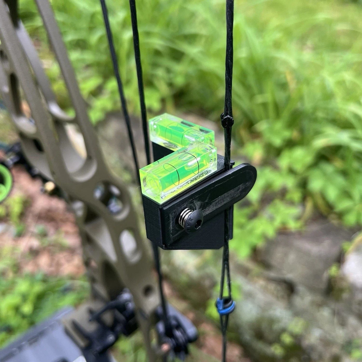 Catalyst Archery bow string level with bubble indicator for precise tuning, mounted on a bow string for accurate archery adjustments.