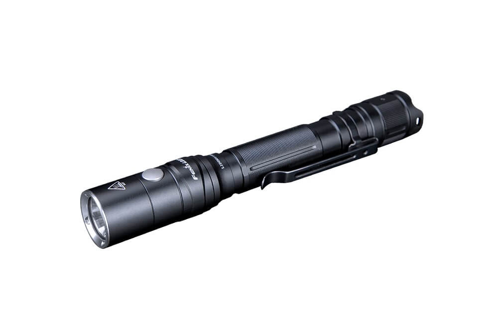 Fenix LD22 V2 compact LED flashlight with 800 lumens, shown in a natural outdoor setting, highlighting its portable design and brightness.