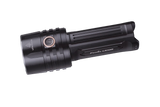 Fenix LR35R rechargeable LED flashlight with 10,000 lumens, black body, turned on beam illuminating a dark area.