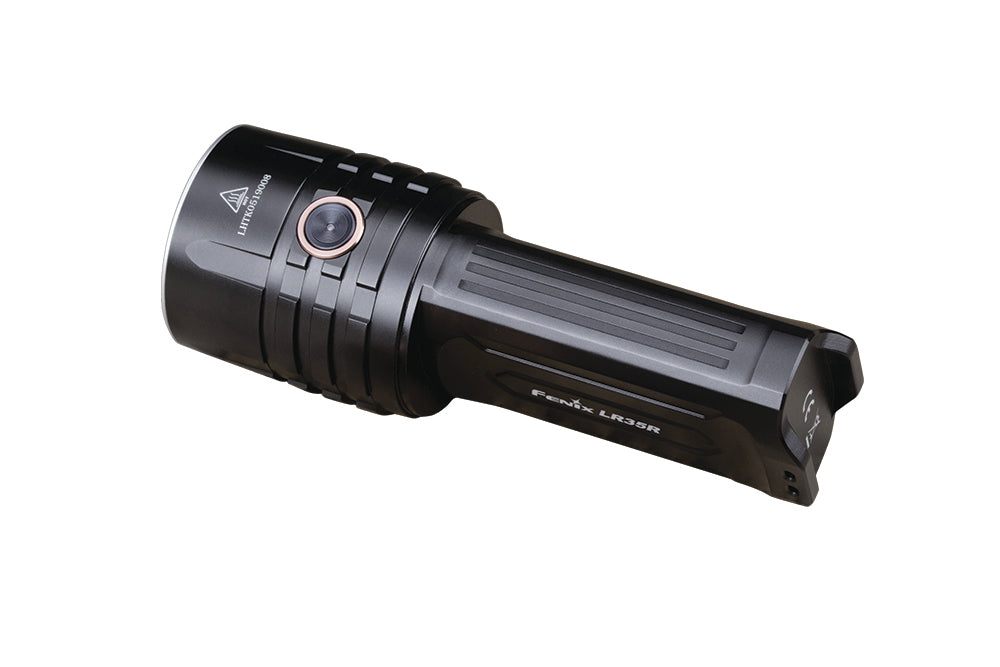 Fenix LR35R rechargeable LED flashlight emitting bright beam, showcasing its compact design and high lumen output.